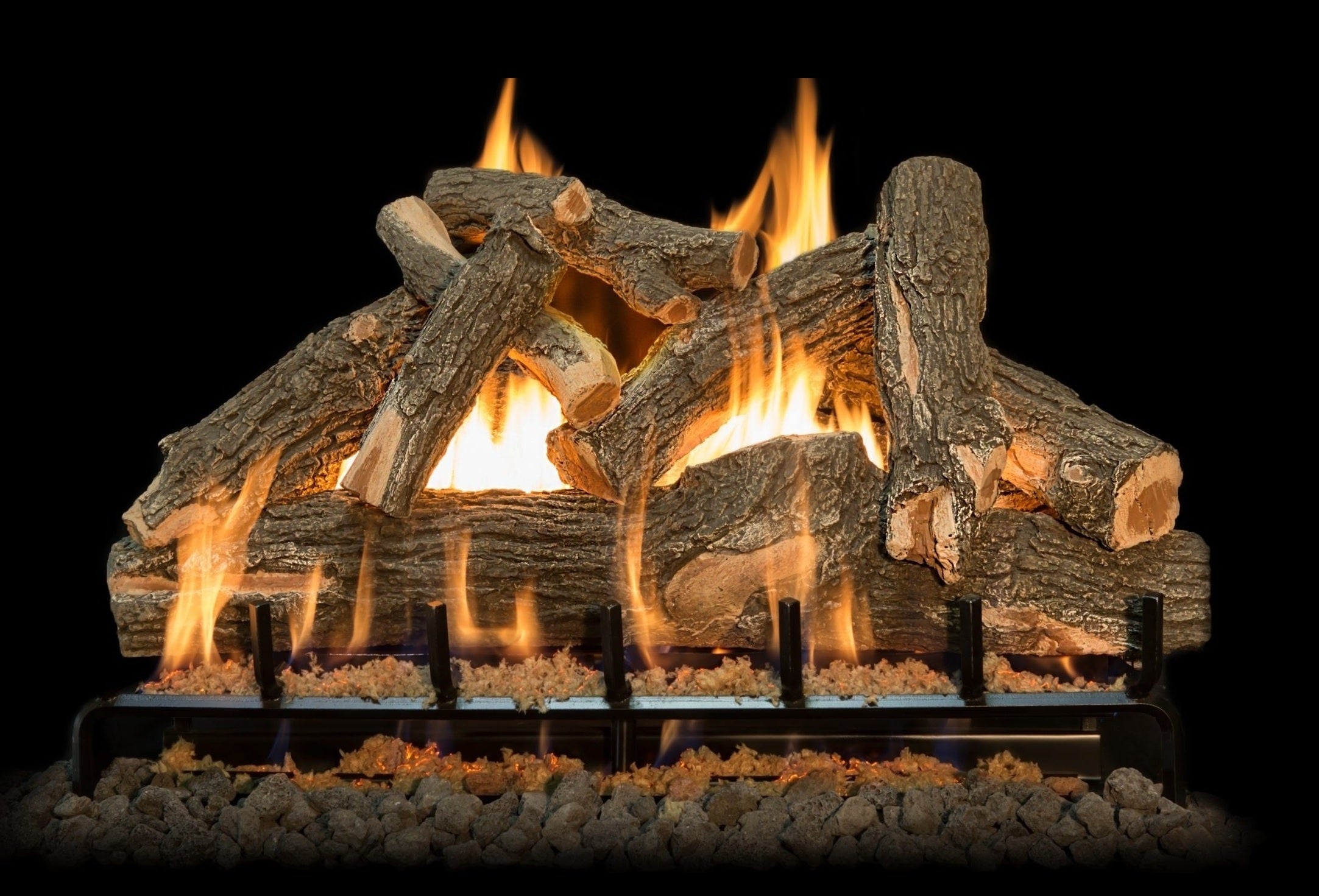 Wooden logs burning in a fireplace with flames against a black background